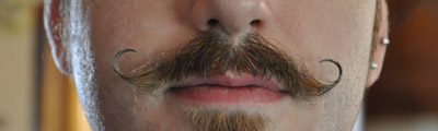 J. M. DeSantis handlebar moustache close up