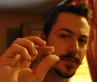 J. M. DeSantis holding moustache wax